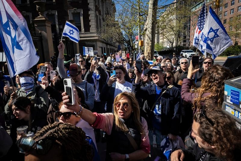 Pro-Israel demonstrators chant "Shame" in support of Columbia University assistant professor Shai Davidai, who was denied access to the main campus to prevent him from accessing the lawn currently occupied by pro-Palestine student demonstrators in New York on Monday, April 22, 2024. (AP Photo/Stefan Jeremiah)