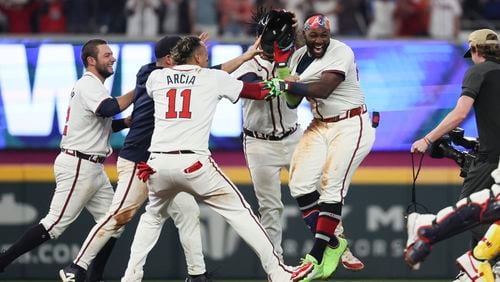 Atlanta Braves center fielder Michael Harris II celebrates with shortstop Orlando Arcia (11) after Harris hit the game-ending walk off hit during the 10th inning against the Miami Marlins at Truist Park, Wednesday, April 24, 2024, in Atlanta. The Braves won 4-3. (Jason Getz / AJC)