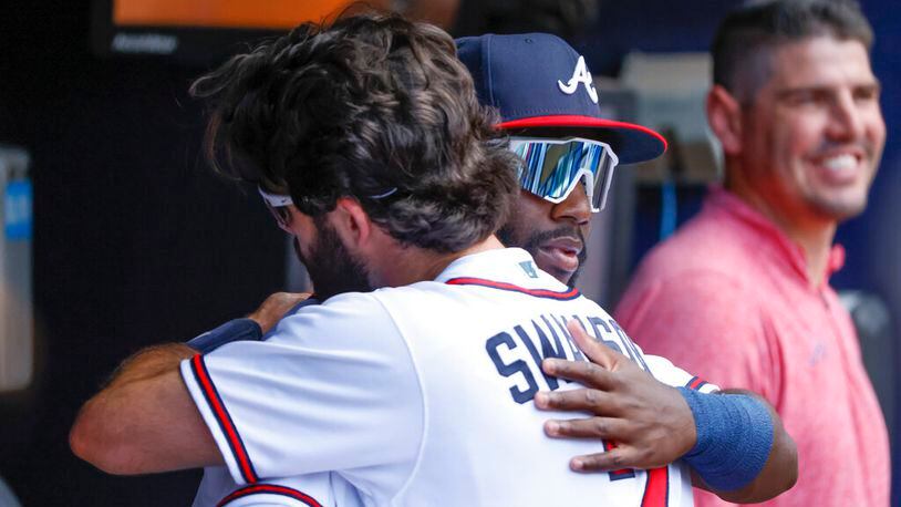 Braves center fielder Michael Harris, front right, making his MLB debut, gets a welcome hug from Dansby Swanson before a baseball game against the Miami Marlins, Saturday, May 28, 2022, in Atlanta. (AP Photo/Bob Andres)