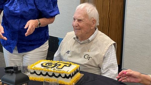 Former Georgia Tech football player Bobby Gaston, a former SEC game official, celebrates his 100th birthday with a Georgia Tech birthday cake Thursday, July 27, 2023, at Savoy Automobile Museum in Cartersville, Ga. His birthday is Oct. 18. (Photo by Chad Bishop/AJC staff)