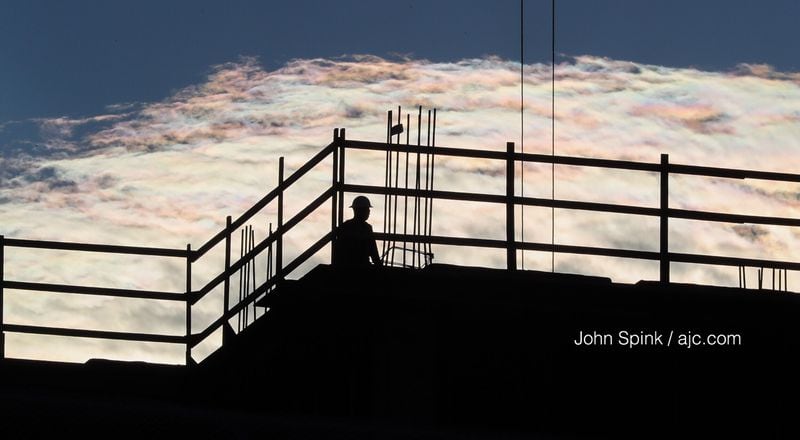 Crews are getting in work at the rising state judicial building downtown before afternoon storms. The site sits across the street from the Gold Dome. JOHN SPINK / JSPINK@AJC.COM