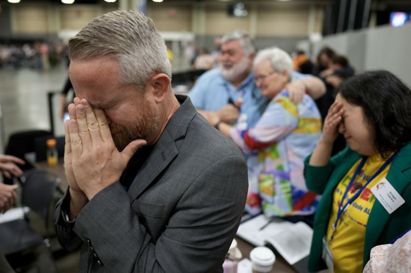 David Oliver reacts after an approval vote at the United Methodist Church General Conference Wednesday, May 1, 2024, in Charlotte, N.C. United Methodist delegates repealed their church’s longstanding ban on LGBTQ clergy with no debate on Wednesday, removing a rule forbidding “self-avowed practicing homosexuals” from being ordained or appointed as ministers. (AP Photo/Chris Carlson)