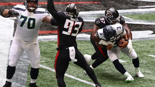 091320 Atlanta: Atlanta Falcons defensive tackle Grady Jarrett sacks Seattle Seahawks quarterback Russel Wilson during the first half Sunday, Sept. 13, 2020, in Atlanta. (Curtis Compton / Curtis.Compton@ajc.com)