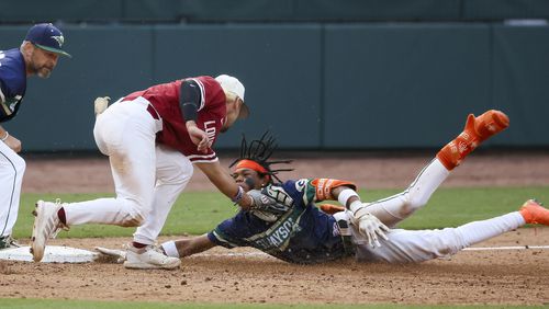 Grayson’s Landon Arroyos (2) slides safely ahead of the tag from Lowndes third baseman Ashton Bohler (5) during the tenth inning in game one of the Class 7A GHSA baseball finals at Coolray Field, Friday, May 17, 2024, in Lawrenceville, Ga. Lowndes won 4-3. (Jason Getz / AJC)
