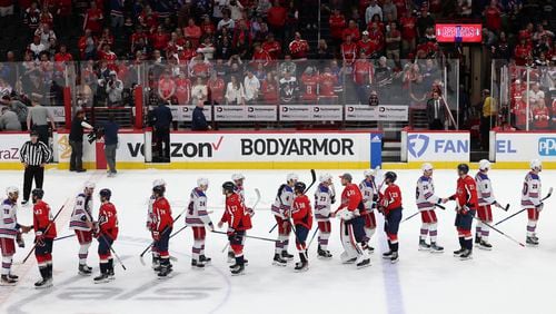New York Rangers players shake hands after defeating the Washington Capitals in Game 4 of an NHL hockey Stanley Cup first-round playoff series, Sunday, April 28, 2024, in Washington. (AP Photo/Tom Brenner)