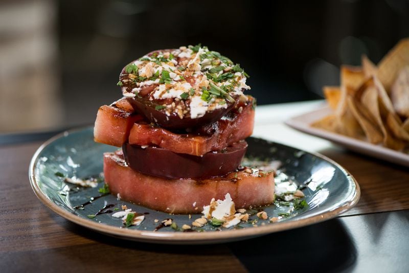  Grilled Watermelon and Heirloom Tomato Stack with feta cheese, marcona almonds, evoo, balsamic, and mint. Photo credit- Mia Yakel.
