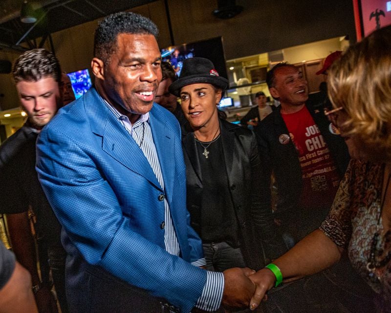 Herschel Walker, front left, and his wife, Julie Blanchard, center, leave Mojitos Bistro in Norcross after a campaign event in September. Blanchard controlled his social media account, chided staff for communicating with reporters and directed his press team to avoid interviews with The Atlanta Journal-Constitution after coverage she didn’t like. One senior Walker strategist said “campaign staff was literally scared to talk to reporters at events” because fears of backlash from Blanchard. (Jenni Girtman for The Atlanta Journal-Constitution)
