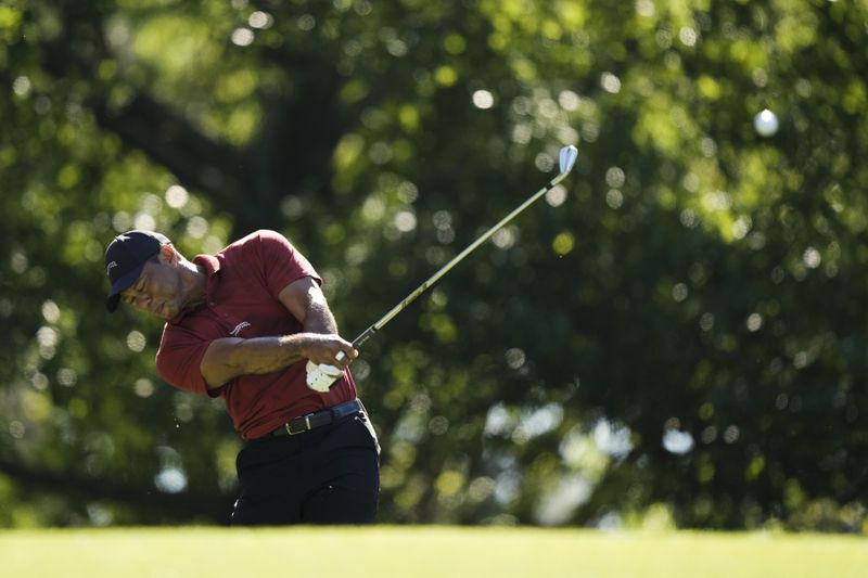 Tiger Woods hits his tee shot on the fourth hole during final round at the Masters golf tournament at Augusta National Golf Club Sunday, April 14, 2024, in Augusta, Ga. (AP Photo/Charlie Riedel)