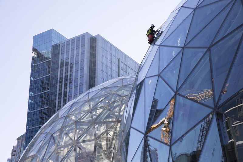 Large spheres in front of Amazon’s building in Seattle. Georgia officials hoping to convince Amazon to build a second headquarters in Atlanta have kept tabs on a brewing controversy in Seattle, where city officials have contemplated enacting a corporate tax based on number of employees, an idea that has frustrated Amazon and a number of other companies. (Ruth Fremson/The New York Times)
