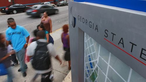 Georgia State students whiz past the corner of Peachtree Center Avenue and Decatur Street.