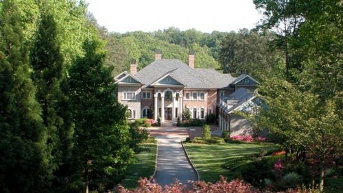 This 13-acre Hall County estate includes a guest house, tennis courts, four-car garage with an apartment and two docks.