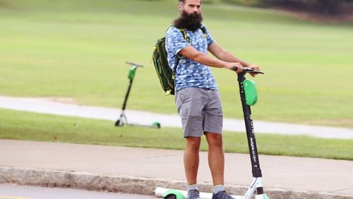 July 18, 2019 Atlanta- A man rides a scooter by Piedmont Park in Atlanta on Wednesday, July 18, 2019. Many Atlantans have embraced e-scooters, while others complain that they violate pedestrians' right of way. Atlanta City Council approved regulations on the scooters at the beginning of 2019, requiring companies to prevent them from being scattered haphazardly on city sidewalks. Christina Matacotta/Christina.Matacotta@ajc.com