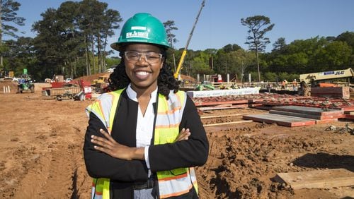 New South Construction project manager Olivia Fru poses for a portrait at the construction site for Peachtree Hills Place, a 55+ living community in the Peachtree Hills Atlanta neighborhood , Wednesday. Fru, a graduate from Southern Polytechnic State University, says she became interested in construction at a young age. She says she enjoyed watching structures go up while living in Camaroon. “It’s like playing Lego,” says Olivia. ALYSSA POINTER/ALYSSA.POINTER@AJC.COM