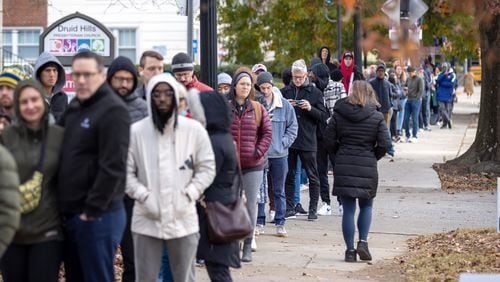 Voters wait in a line stretching down the road from Joan P. Garner Library at Ponce de Leon on the last day of early voting in metro Atlanta on Friday, December 2, 2022.   (Arvin Temkar / arvin.temkar@ajc.com)