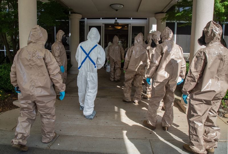 The 265th Infectious Control GA Army National Guard enters the Canterbury Court, a senior living facility in Buckhead, to disinfect the building on Friday, April 10, 2020. (STEVE SCHAEFER / Special to the AJC)