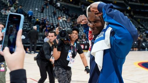Minnesota Timberwolves guard Anthony Edwards flexes for a team social media worker while heading off the court after Game 2 of an NBA basketball second-round playoff series against the Denver Nuggets, Monday, May 6, 2024, in Denver. (AP Photo/David Zalubowski)