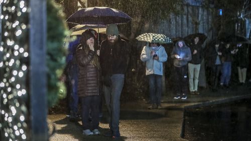 Voters lined up in the rain on Tuesday, Dec. 6, 2022, at Park Tavern in Atlanta for the U.S. Senate runoff between Democrat Raphael Warnock and Republican Herschel Walker. (John Spink / John.Spink@ajc.com)
