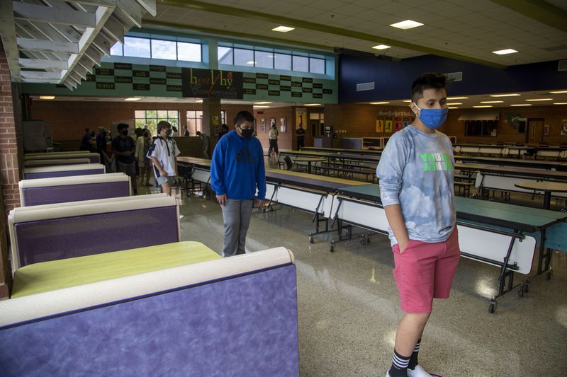 Students stand socially distant in the cafeteria as they purchase their school lunches at Cartersville Middle School in Cartersville, Thursday, August 20, 2020. (ALYSSA POINTER / ALYSSA.POINTER@AJC.COM)