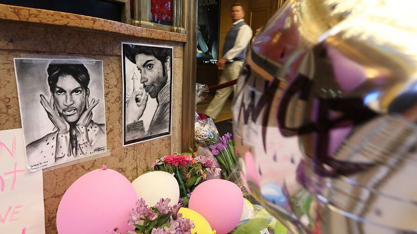 Drawings, flowers and balloons form a memorial to Prince in front of the Fox Theatre, where the musician played his final public concert a week before he died.