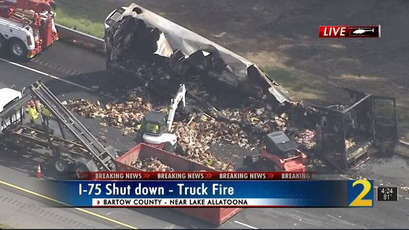 The contents of the truck were scattered across the surface of I-75 after a fire.