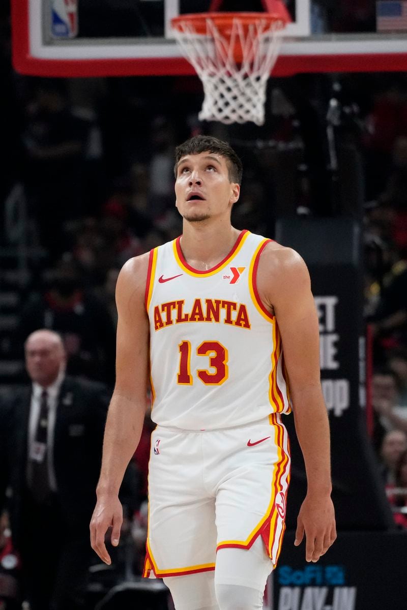 Atlanta Hawks guard Bogdan Bogdanovic looks up the scoreboard as he walks to the bench during the first half of the team's NBA basketball play-in tournament game against the Chicago Bulls in Chicago, Wednesday, April 17, 2024. (AP Photo/Nam Y. Huh)