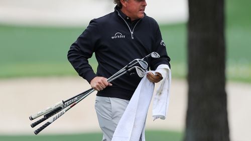 Phil Mickelson carrys some wedges while he gets in some practice for the Masters at Augusta National Golf Club on Wednesday, April 4, 2018, in Augusta.  Curtis Compton/ccompton@ajc.com