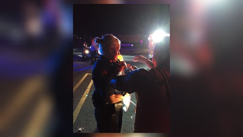 Douglasville police Officer Candace Tongate holds baby she delivered after traffic stop. (Credit: Candace Tongate)
