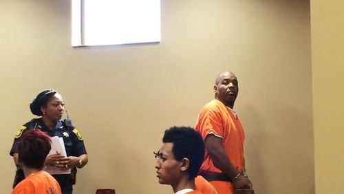 Charles Richey, standing at right, leaves a 2017 court hearing after a detective laid out the case against Richey, who is accused of murder in the death of a MARTA panhandler on a train.
