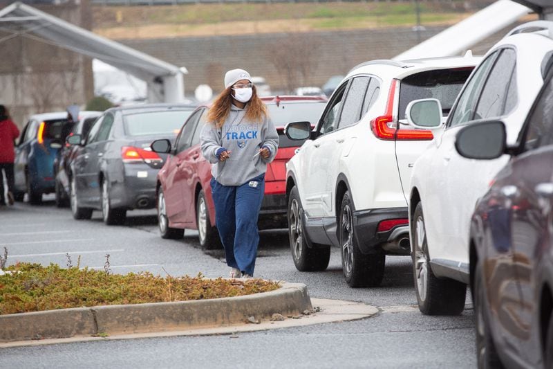 Cars line up to receive the COVID-19 vaccine at a vaccination center in Doraville Monday. STEVE SCHAEFER FOR THE ATLANTA JOURNAL-CONSTITUTION