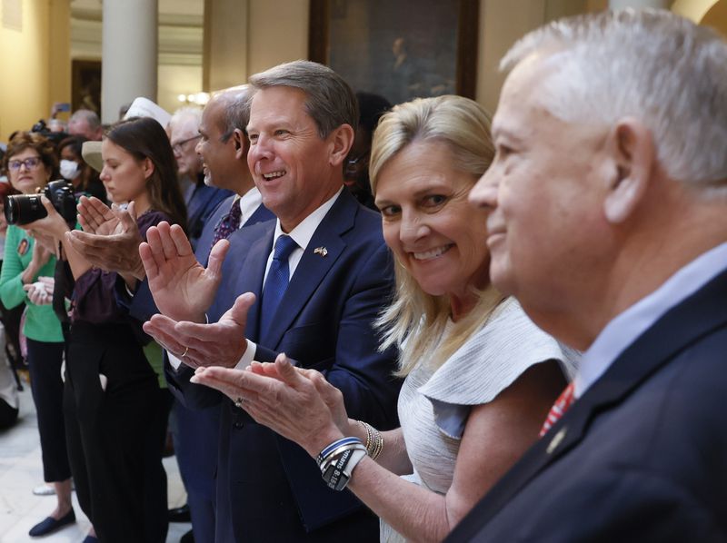 Gov. Brian Kemp, with his wife, Marty, applauds House Speaker Ralston before he signed HB 1013, which aims to increase access to mental health coverage in Georgia on Sine Die, the last day of the General Assembly at the Georgia State Capitol in Atlanta on Monday, April 4, 2022.   (Bob Andres / robert.andres@ajc.com)