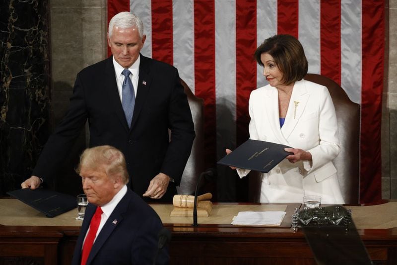President Donald Trump turns after handing copies of his speech to House Speaker Nancy Pelosi and Vice President Mike Pence. (AP Photo/Patrick Semansky)