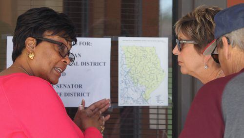 April 10, 2017, Atlanta, Georgia - An election worker looks over the map of the 6th district with residents that arrived to vote at the Marietta Elections Main Office in Marietta, Georgia, on April 10, 2017. Officials said a number of people who were not eligible to vote in the election because they did not live in the district arrived on both Saturday and Monday. (HENRY TAYLOR / HENRY.TAYLOR@AJC.COM)
