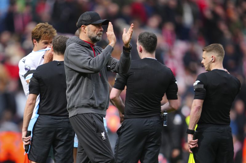 Liverpool's manager Jurgen Klopp applaud supporters at the end of the English Premier League soccer match between Liverpool and Crystal Palace at Anfield Stadium in Liverpool, England, Sunday, April 14, 2024. (AP Photo/Jon Super)
