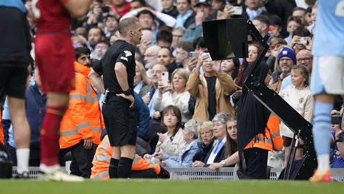 Referee checks VAR for penalty during the English Premier League soccer match between Manchester City and Wolverhampton Wanderers at the Etihad Stadium in Manchester, England, Saturday, May 4, 2024. (AP Photo/Dave Thompson)