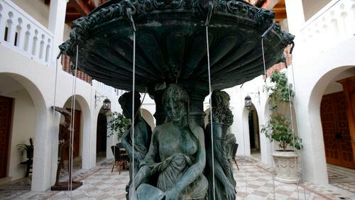 A fountain in the courtyard of the Versace Mansion in Miami Beach. Modeled after Alcazar de Colon, the Dominican Republic house built by Christopher Columbus' family in 1510, Casa Casuarina is a three-story, Mediterranean-style home surrounded by a high wall on a fashionable stretch of Ocean Drive. It was built in 1930 by Standard Oil heir Alden Freeman, later became a hotel, spiraled into disrepair, and was at one point a hostel with rooms as little as $1 a night. Two men were found dead Wednesday inside a luxury hotel room at the former Versace Mansion in Miami Beach where the acclaimed fashion designer was shot to death 24 years ago.
