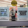 A sign on the entrance to a pharmacy reads "Covid-19 Vaccine Not Yet Available" on November 23, 2020 in Burbank, California. (Robyn Beck/AFP via Getty Images/TNS)