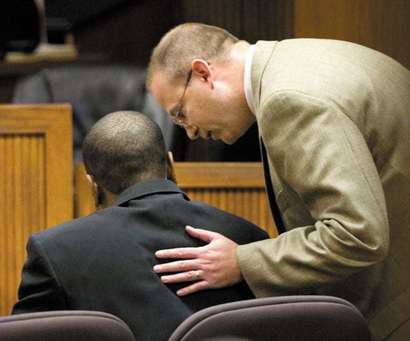 Defense attorney Jeremy Armstrong (right) talks with Courtney Lockhart as they prepare to hear the verdict in 2011. (Photo: Robin Trimarchi, Ledger-Enquirer)