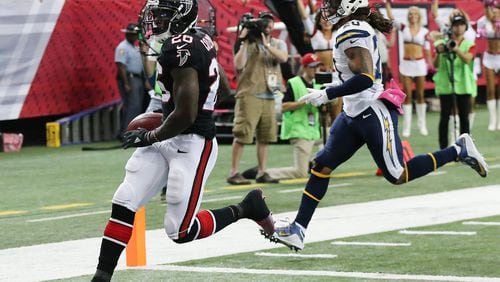 Falcons running back Tevin Coleman gets past Chargers safety Dwight Lowery for a touchdown and a 20-10 lead during the second quarter in an NFL football game on Sunday, Oct. 23, 2016, in Atlanta. Curtis Compton /ccompton@ajc.com