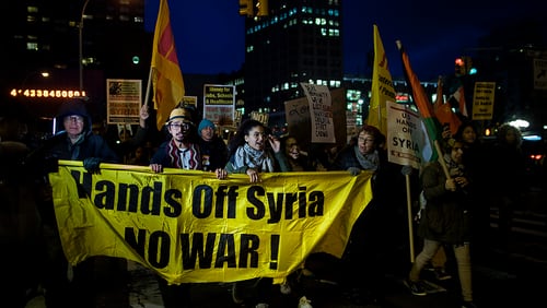 Protesters march during a rally against the U.S. missile strikes in Syria, Friday, April 7, 2017, in New York. The U.S. fired a barrage of cruise missiles into Syria on Thursday night in retaliation for a chemical weapons attack against civilians earlier in the week. (AP Photo/Andres Kudacki)