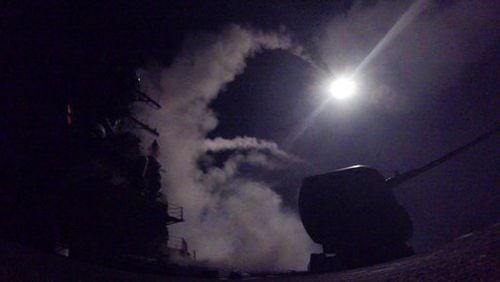In this image provided by the U.S. Navy, the guided-missile destroyer USS Porter (DDG 78) launches a tomahawk land attack missile in the Mediterranean Sea, Friday, April 7, 2017. The United States blasted a Syrian air base with a barrage of cruise missiles in fiery retaliation for this week's gruesome chemical weapons attack against civilians.  (Mass Communication Specialist 3rd Class Ford Williams/U.S. Navy via AP)