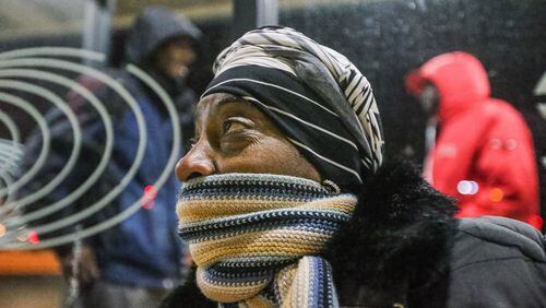 Viola Harshaw bundled up early Friday as she waited for a Cobb Community Transit bus at the Marietta Transfer Center. JOHN SPINK / JSPINK@AJC.COM