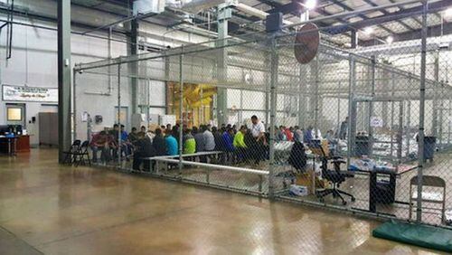Children separated from their parents at the border are warehoused in chain-metal fencing in a former Wal-Mart facility. The lights at the facility are kept on 24 hours a day.