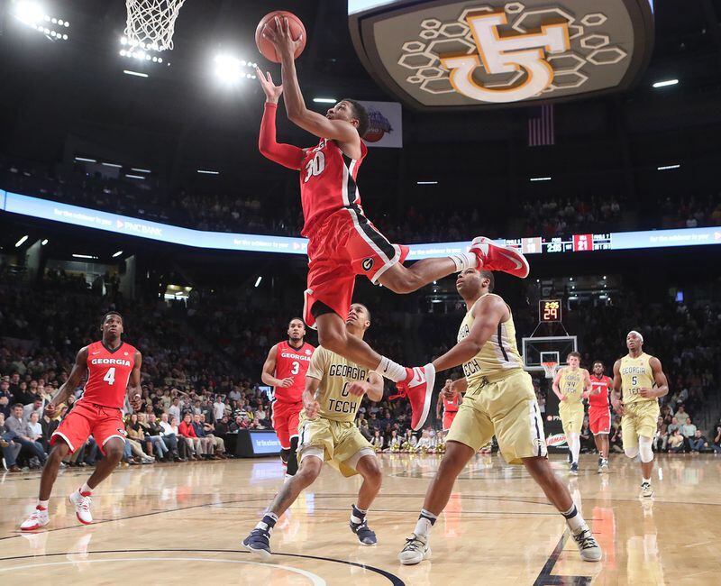Georgia guard J.J. Frazier soars for two points over Georgia Tech guards Justin Moore (left) and Corey Heyward in a NCAA college basketball game on Tuesday, Dec. 20, 2016, in Atlanta. Curtis Compton/ccompton@ajc.com