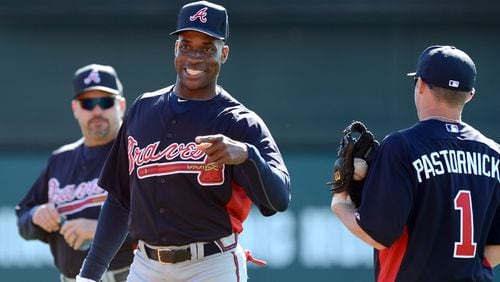 Former Brave Fred McGriff smiles as he talks with infielder Tyler Pastornicky at spring training Feb. 19, 2013 at Champion Stadium in the ESPN Wide World of Sports Complex in Lake Buena Vista, Fla. HYOSUB SHIN / HSHIN@AJC.COM
