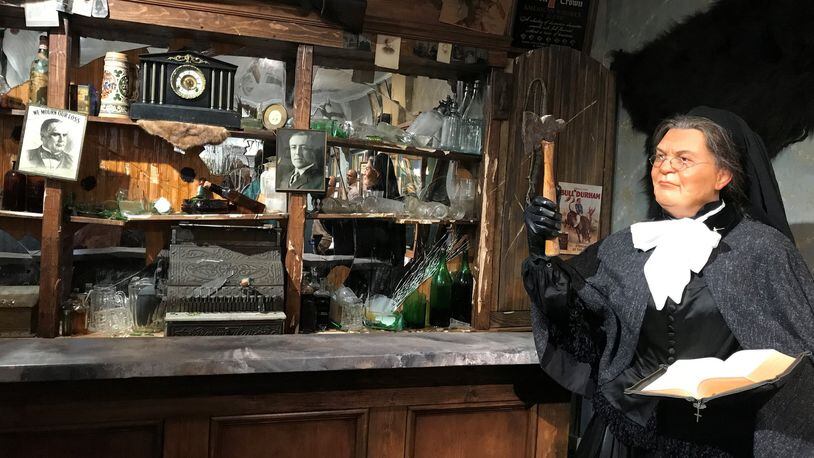 At the American Prohibition Museum in Savannah, a wax figure of Temperance Movement leader Carry A. Nation stands next to a bar smashed with an ax. Photo by Ligaya Figueras.