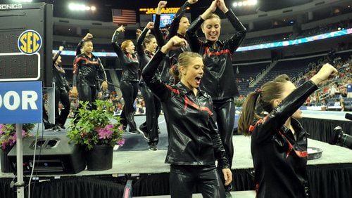 University of Georgia gymnasts cheer as they move to the vault category.