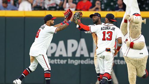 Atlanta Braves outfielders Eddie Rosario (from left), Michael Harris and Ronald Acuna celebrate a 13-1 victory over the Philadelphia Phillies during a MLB baseball game on Tuesday, Aug. 2, 2022, in Atlanta.  Curtis Compton / Curtis Compton@ajc.com