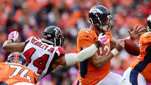 Denver quarterback Paxton Lynch is under pressure from the Falcons’ Vic Beasley on Sunday. (Photo by Dustin Bradford/Getty Images)