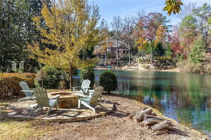 Enjoy resort-style living ITP at this $8.7M estate with private lake