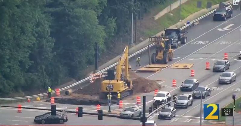 Crews are working to repair a large sinkhole at the I-285 off-ramp to Cobb Parkway.